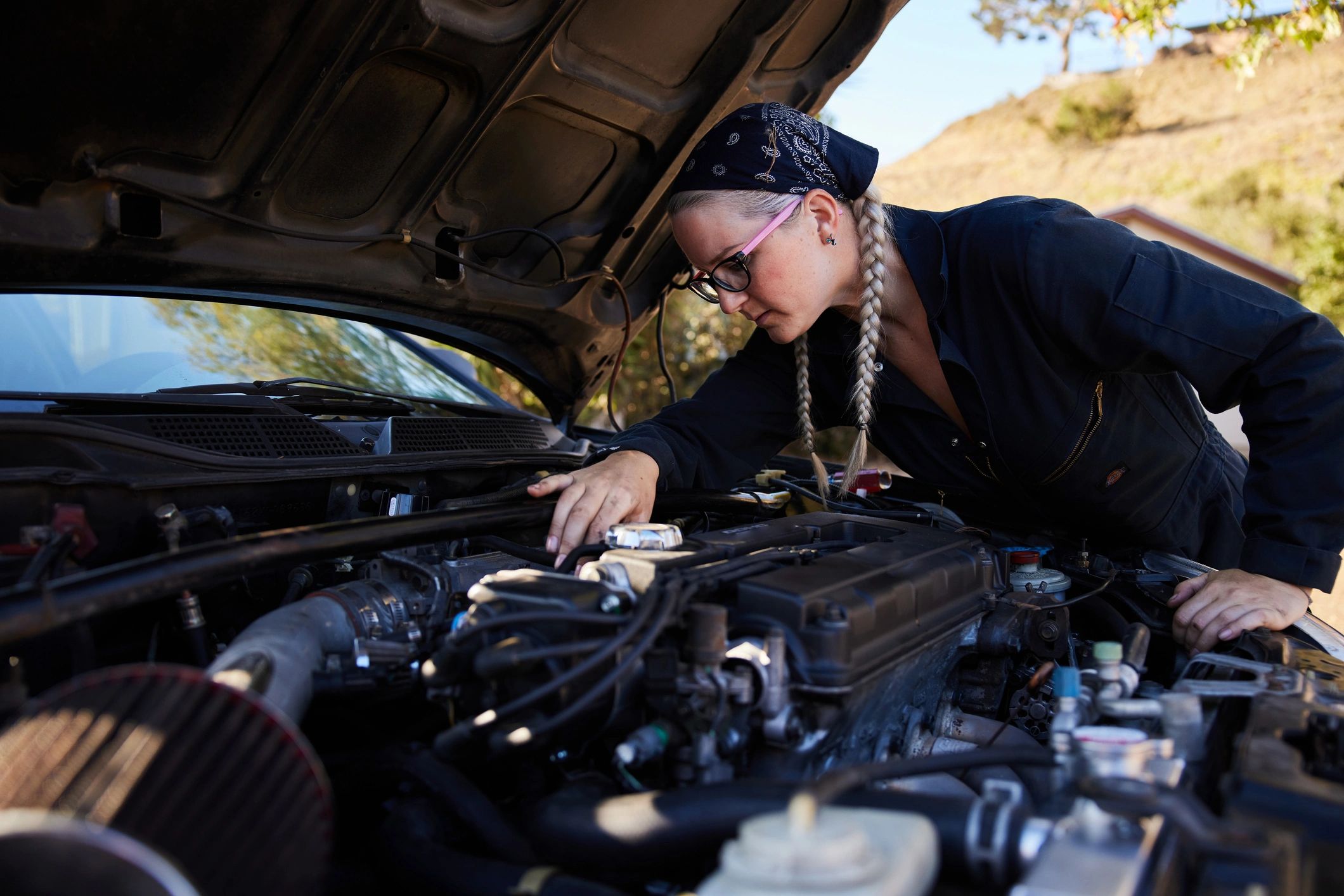 Mechanic inspecting an engine bay during repair