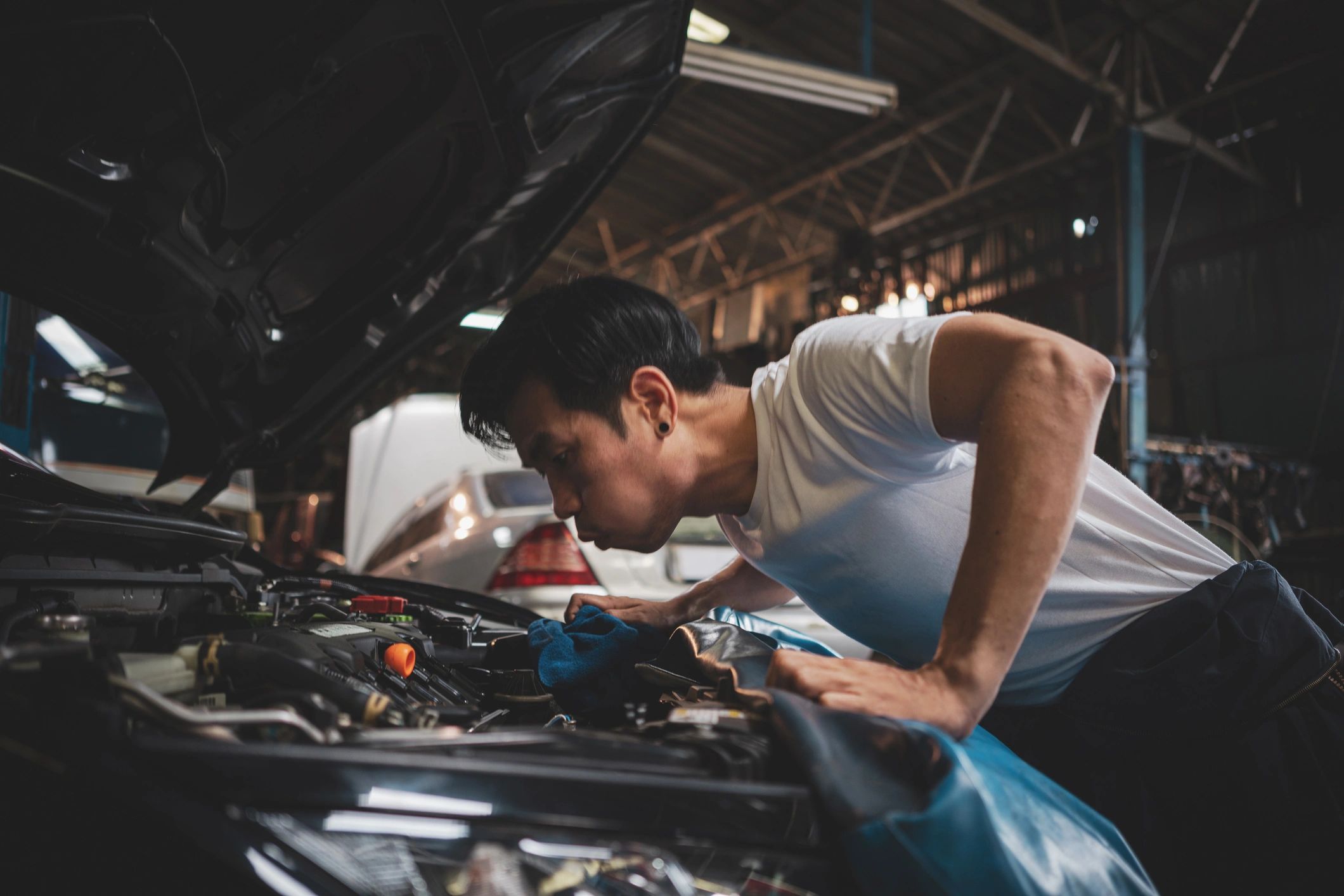 Technician inspecting an engine during a maintenance check