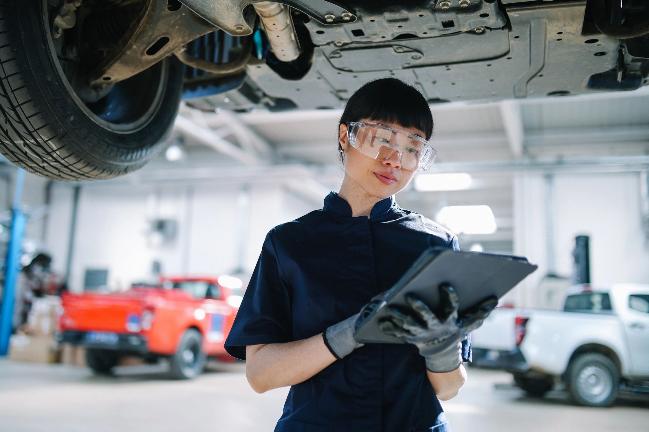 Mechanic performing diagnostics with a tablet in an auto repair shop