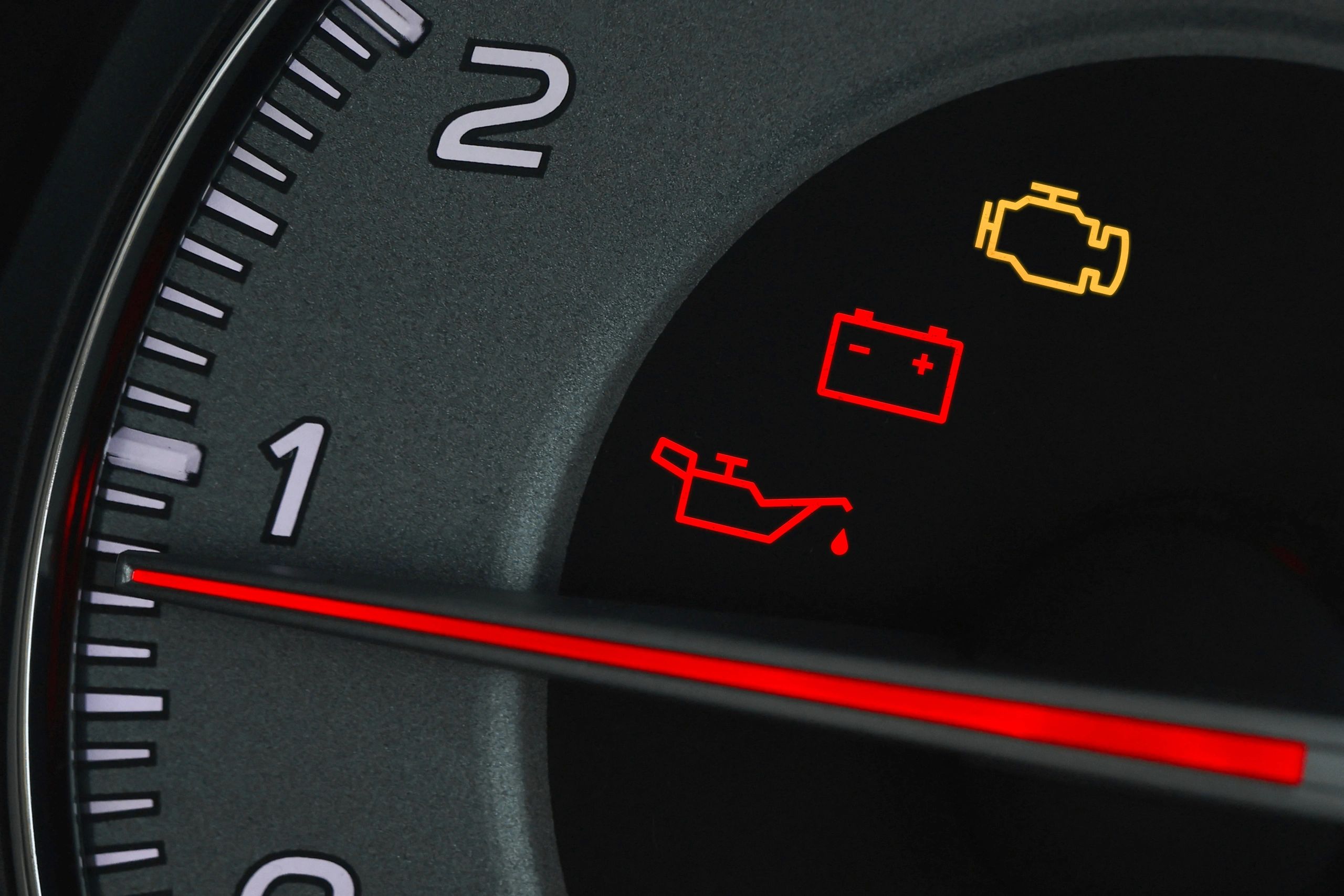 Car dashboard with check engine warning light illuminated