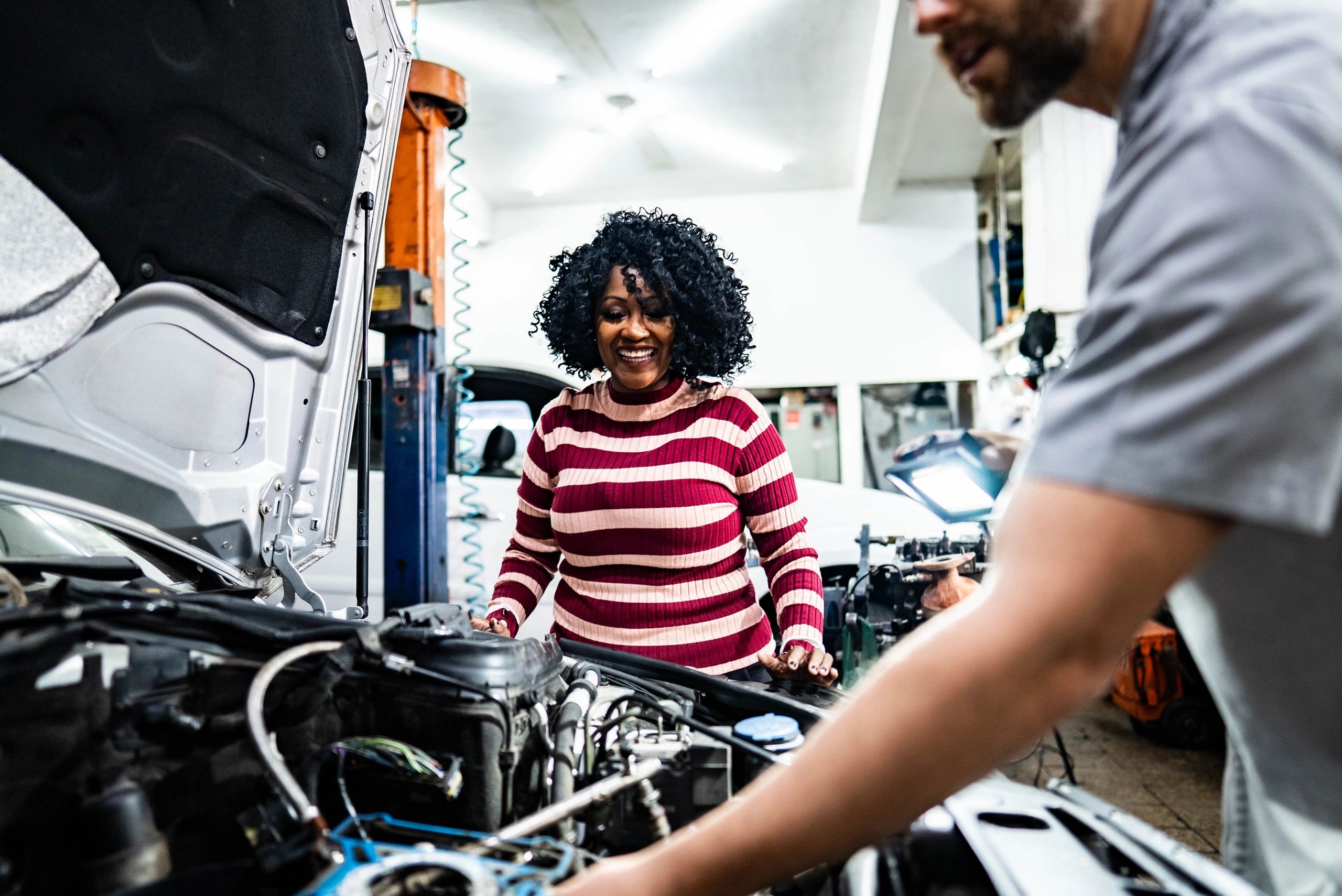 Customer discussing service with a mechanic at the counter